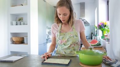 focused-young-woman-consulting-recipe-while-cooking-her-kitchen-using-tablet-near-big-saucepan-counter-front-view-cooking-home-internet-concept_74855-7288-2158065