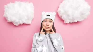 woman-makes-smiles-keeps-fingers-near-corners-mouth-wears-soft-bear-hat-casual-jumper-looks-isolated-pink_273609-48931-9256838