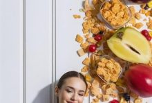 beautiful-young-woman-eating-cereals-fruits-white-background_1042628-548716-8356130