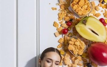 beautiful-young-woman-eating-cereals-fruits-white-background_1042628-548716-8356130