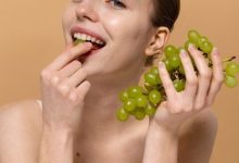 medium-shot-smiley-woman-with-grapes_23-2149408717-6565850